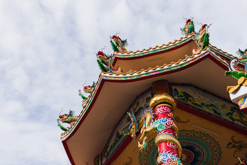 The Chinese temple with colorful dragons under the sky and cloud