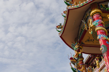 The Chinese temple with colorful dragons under the sky and cloud