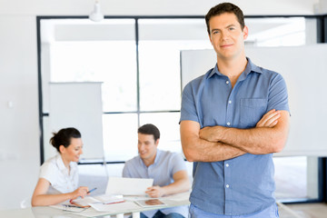 Young caucasian businessman standing in office