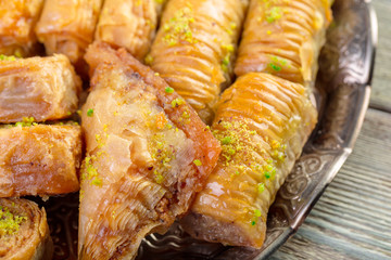 Turkish sweets baklava and metal oriental tray on wooden background