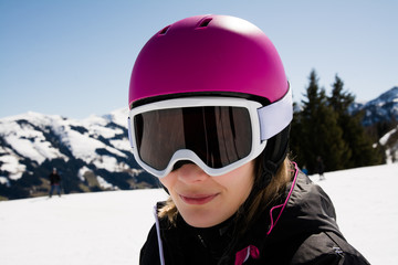 Fototapeta na wymiar portrait of Woman in ski outfit at top of mountain