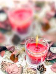 Christmas greeting card, composition with red candle in warm natural environment, Auguri di Natale con candela rossa in ambiente naturale 