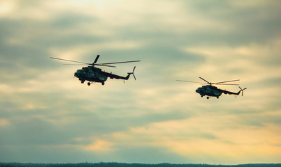 Helicopter in flight at sunset in summer