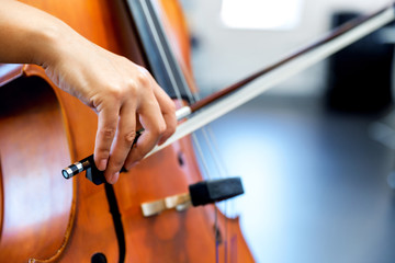 Close up of cello with bow in hands