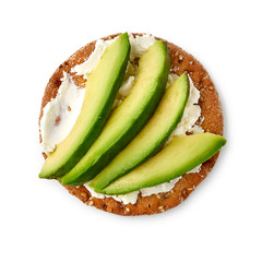 Cracker with cream cheese and avocado slices