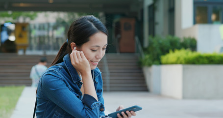 Woman listen to music on mobile phone