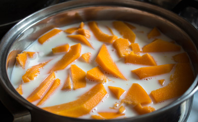 a pumpkin sliced with milk in the pan