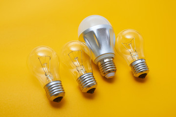 Led light bulb lay next to incandescent bulb. Concept energy saving