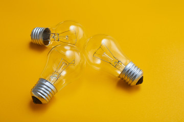 close up view of white light bulb isolated on yellow