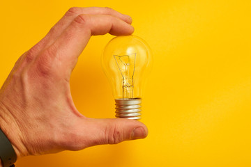 close up view of white light bulb isolated on yellow