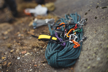 Obraz premium Climbing rope and other tools lying on the rocks closeup. Tilt-Shift effect.