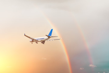 Airplane and beautiful rainbow in the sky