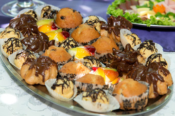 Catering sweets, closeup of various kinds of cakes on event or wedding reception  - selective focus