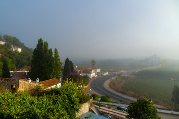 View of the old part of Obidos, Portugal in the early foggy morning