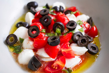 Mozzarella, tomato cherry, basil and olives salad