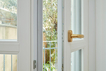 New, white double glazed open window with golden handle