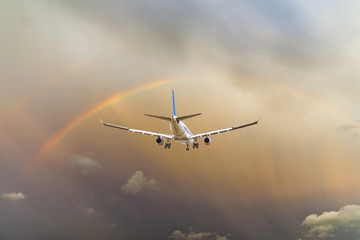 Airplane and beautiful rainbow in the sky