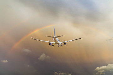 Airplane and beautiful rainbow in the sky