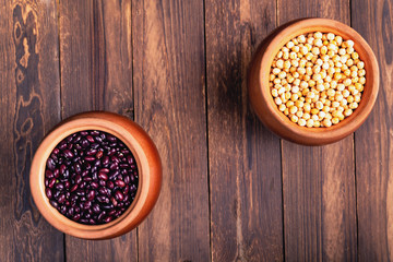 The concept of natural healthy food. Grains of various beans in a large ceramic pots, closeup. Superfood