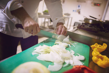 Chef hands cutting fresh and delicious vegetables