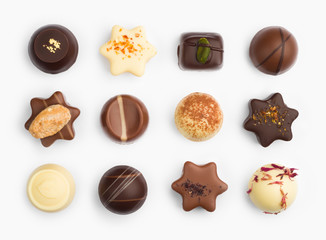 Top view of various chocolate pralines isolated on white background