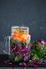 Salad of red cabbage, carrots and greens in a jar. healthy eating. Selective focus.