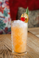 alcohol cocktail with cherry on it on the table in the bar