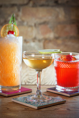 different colorful alcohol and non-alcohol cocktails in the glasses on the table