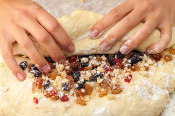 Wrapping candied fruit in the dough for mixing