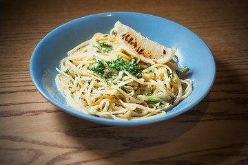 pasta with creamy sauce in blue plate