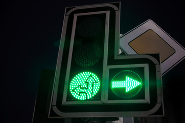 Traffic lights at night, all signals are go.