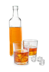 Bottle and glasses of whisky on white background