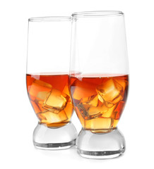 Glasses of whisky with ice on white background