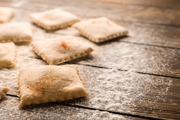 Tasty ravioli on wooden table, closeup