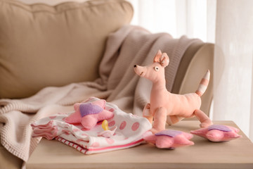 Obraz na płótnie Canvas Baby clothes and toys on table