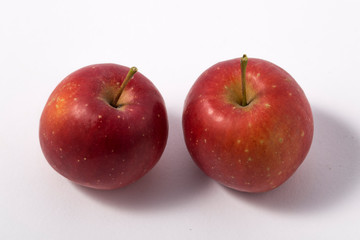 Small apple with green leaf on white background. ranetka
