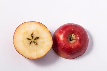Small apple with green leaf on white background. ranetka