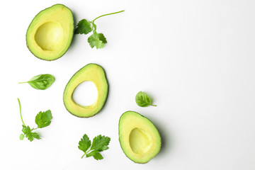 Composition with cut avocado on white background