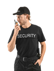 Male security guard with portable radio transmitter on white background