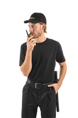 Male security guard with portable radio transmitter on white background