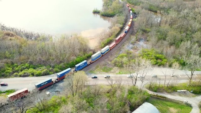 Cargo Train crossing the highway stopping traffic