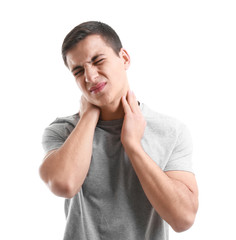 Young man suffering from neck pain on white background