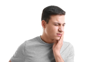 Obraz premium Young man suffering from toothache on white background