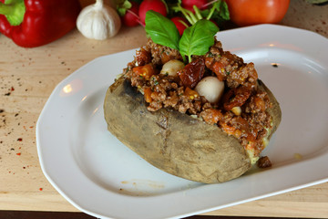 Kumpir - Traditional Turkish meal with baked potato, butter, cheese, bulgur salad, beef meat, mozzarella meat, tomato sauce and hot spices