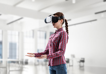 Girl in virtual reality mask experiencing virtual technology wor