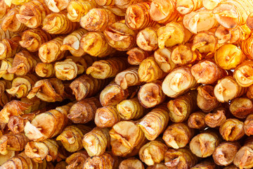 Many sticks with round fried potatoe chips