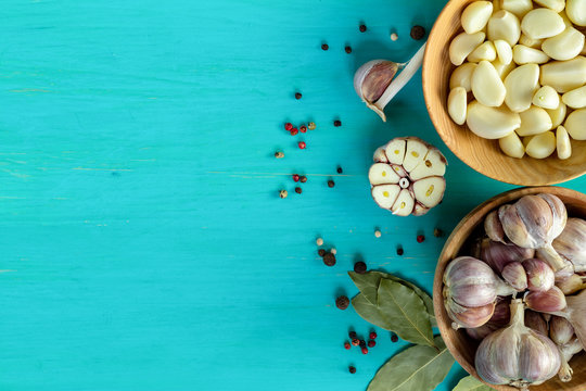 Fresh garlic heads, cloves set on a blue turquoise wooden surface, copy space