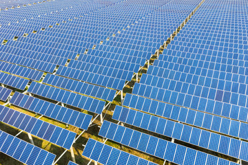 arrays of blue solar panels on photovoltaic power station
