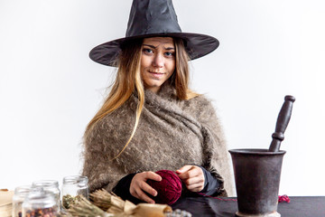 A young woman wearing a witch costume