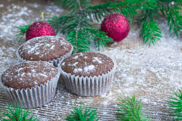 Three Christmas cakes, winter snowbound wooden background, red balls ornament